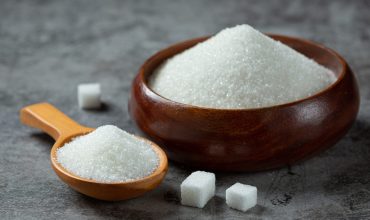 World diabetes day; sugar in wooden bowl on dark background