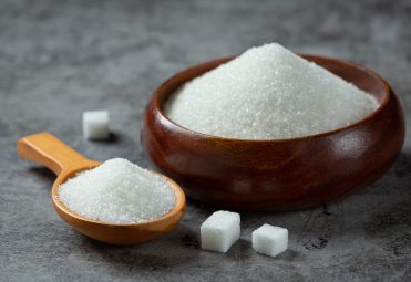 World diabetes day; sugar in wooden bowl on dark background