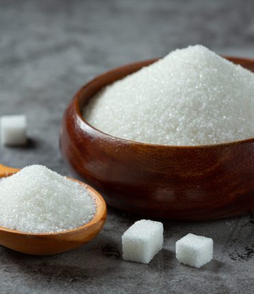 World diabetes day; sugar in wooden bowl on dark background