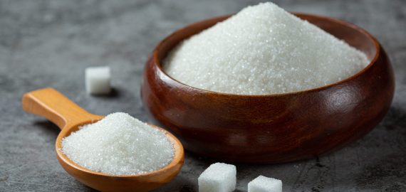World diabetes day; sugar in wooden bowl on dark background World diabetes day; sugar in wooden bowl on dark background